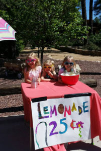 Girls selling lemonade for Shoes That Fit.