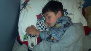 Kid sleeps with shoe
