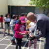 Students in Fresno get new shoes and show them off to the principal