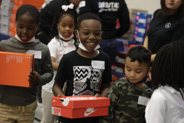 Children receiving shoes in last year's Season to Shine!